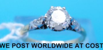 An 18ct gold ring set with a round brilliant cut diamond measuring approximately 0.