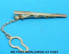 A 9ct gold tie clip (3.