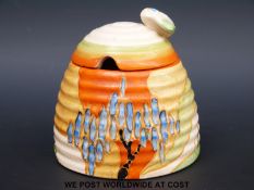 A Clarice Cliff honey pot with bee finial (9cm tall)