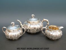 A Chinese silver tea set in a stylized bamboo design with all over bamboo and prunus decoration,