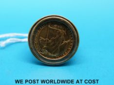 A gold ring set with a Britannia 1/10 oz gold coin (7.