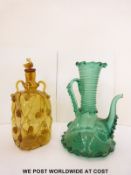 A green glass ewer with applied decoration together with an amber glass decanter with applied and