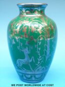 A Richard Ginori Art Deco vase decorated with silver lustre deer and foliage against a green ground