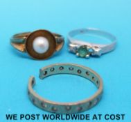 A yellow metal ring marked 333 set with a pearl,