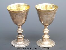 A pair of white metal miniature goblets, marked to underside + IK, length 6.