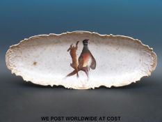 A large Limoges oval platter with gadrooned edge decorated with a hare and pheasant (60 x 24cm)