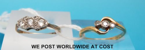 A yellow metal ring marked 18ct set with three diamonds in a twist setting and a yellow metal ring