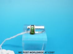 A white metal ring marked 14k set with green tourmaline (size N)