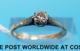 A yellow metal ring set with a diamond in an illusion setting (size O)