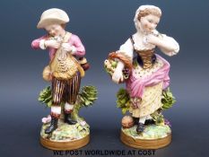 A pair of 19thC Derby figures, the girl holding a basket of fruit and flowers,