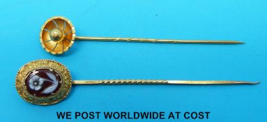 A Victorian stick pin marked 15ct and a Victorian yellow metal stick pin set with an agate cameo of