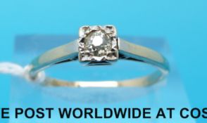 A yellow metal ring marked 9ct set with a diamond in a platinum setting (size O)