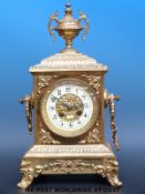 A circa early 20thC brass cased bracket style two train clock with spandrel decoration,