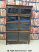 An oak Globe Wernicke style four section bookcase with double opening doors to each section (width