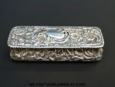A hallmarked silver trinket box with embossed decoration of flowers and foliage, Chester 1897,