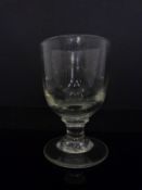 PLEASE NOTE CHANGE TO PRINTED CATALOGUE DESCRIPTION. A Georgian clear glass rummer on folded foot.