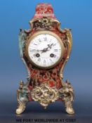 A Boulle clock with Roman and Arabic numerals and two train movement,