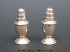 A pair of white metal miniature or doll's house peppers, height 4cm,