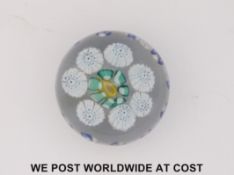 St Mande patterned millefiori glass paperweights with central yellow cane surrounded by a band of