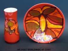 A Poole signed jug and dish with abstract design on a red ground