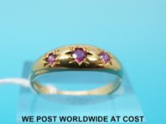 A 9ct gold ring set with three rubies (size P)