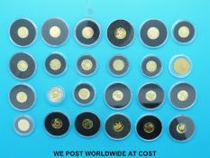 Twenty four various small / miniature gold coins in a wooden Westminster case