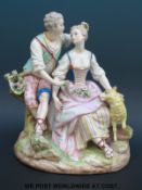 A 19th/20thC continental figural group of sweethearts with a lamb at foot (20cm tall)