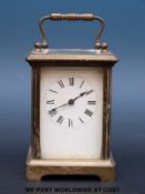 A French brass carriage clock with enamelled dial and blued spade hands
