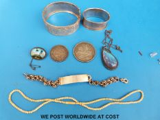 A Victorian white metal bangle, hallmarked silver napkin ring, hallmarked silver identity bracelet,