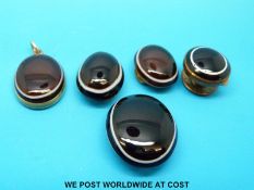 A yellow metal pendant set with a banded agate cabochon, verso plaited hair,