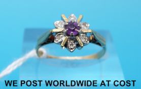 An 18ct gold ring set with an amethyst surrounded by diamonds (size M)