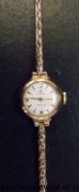 Cyma Cymaflex ladies 9ct gold wristwatch with gold hands and markers on white face,