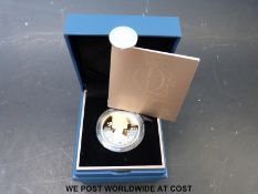 A proof silver gold plated £5 coin to commemorate the Queen's Diamond Jubilee,