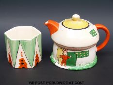 A small Mabel Lucie Attwell teapot in the shape of a pixie's house together with a piece of Ivory