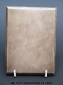 A Garrard & Co Ltd hallmarked silver cigarette case with slide to open mechanism, length 11.