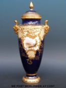 A 19thC Coalport twin handled pedestal vase with hand decorated cartouches,