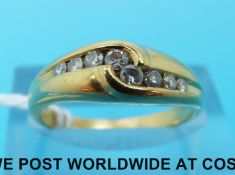 An 18ct gold ring set with eight diamonds (size L)