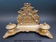 A brass inkwell/desk tidy,