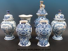 A collection of 18th century Delft vases, some with covers,