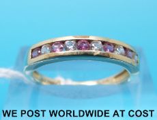 A 9ct gold ring set with alternating pink and white sapphires (size L)