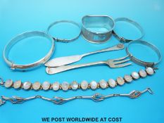 A hallmarked silver napkin ring, three silver christening bangles,