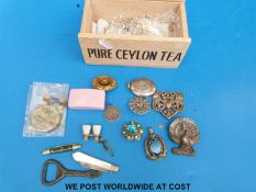 A small collection of jewellery to include a Victorian silver locket, white metal peacock brooch,