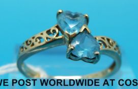 A 9ct gold ring set with two blue heart shaped topaz (size Q)