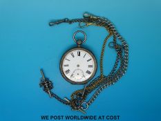 A hallmarked silver cased pocket watch with several chains