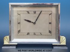 An 8 day Deco mantel clock in chrome plated rectangular case raised on faux onyx feet