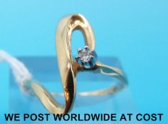 A white metal ring marked 10k set with a diamond (size Q)