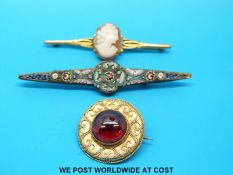 A yellow metal brooch set with a cameo,