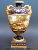 A Copeland pedestal urn decorated with two scenes, one haymaking,