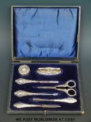 A cased hallmarked silver-mounted manicure set