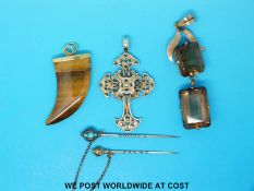 A yellow metal stick pin set with turquoise, a yellow metal pendant set with two smoky quartz,